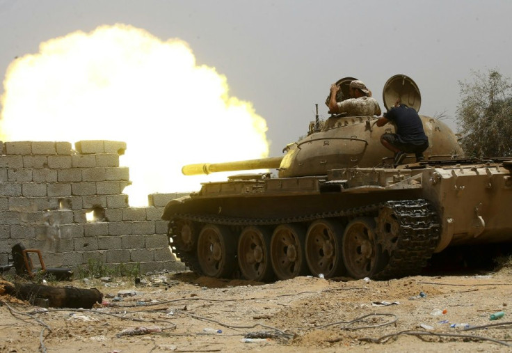 A file photo from June 2019 shows fighters loyal to the UN-recognised Government of National Accord (GNA) open tank fire south of the Libyan capital Tripoli during clashes with forces loyal to strongman Khalifa Haftar