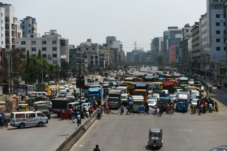 A road blocked by protesters in Dhaka. Bangladesh has announced $590 million in loans for export-oriented factories to pay workers