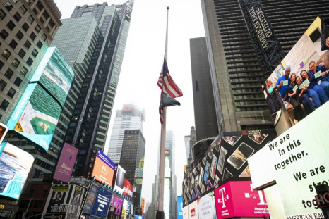 The US flag is seen at half-mast at the almost deserted Times Square on April 13, 2020 in New York City
