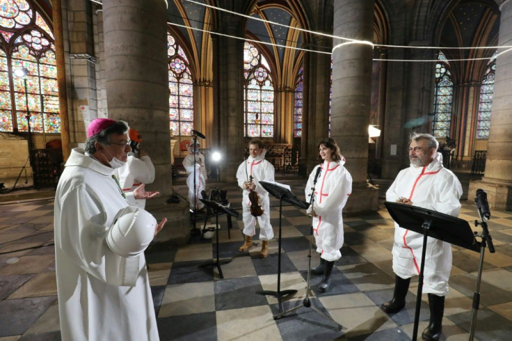 Paris Archbishop Michel Aupetit, left, lead a Good Friday prayer ceremony at Notre-Dame last week.