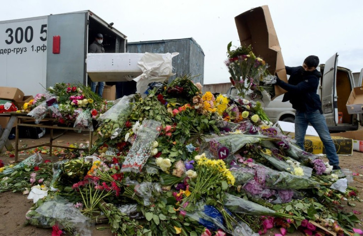 Flower shop employees destroy unsold bouquets as business are hit by a slow-down