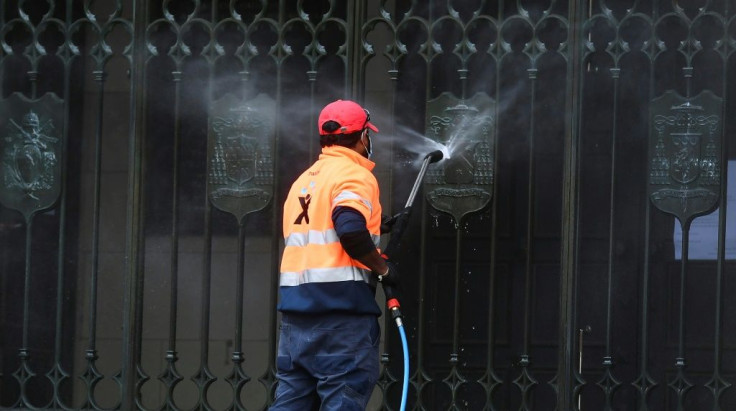 A worker cleans the entrance to St Patrick's Cathedral in Melbourne after it was vandalised following Cardinal George Pell's release from prison