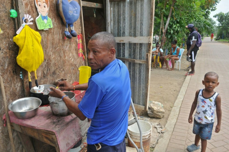 A man prepares a meal in a street in the Nigeria neighborhood of Guayaquil, the Ecuadoran city hardest hit by COVID-19.