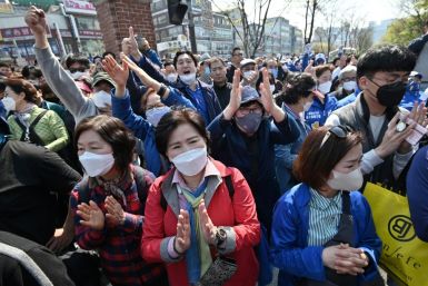 Supporters wearing facemasks listen to a stump speech by former South Korean prime minister Lee Nak-yon, a  candidate for the ruling Democratic Party in parliamentary elections