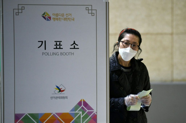 A South Korean woman casts her ballot for the parliamentary elections at a polling station in Seoul on April 15