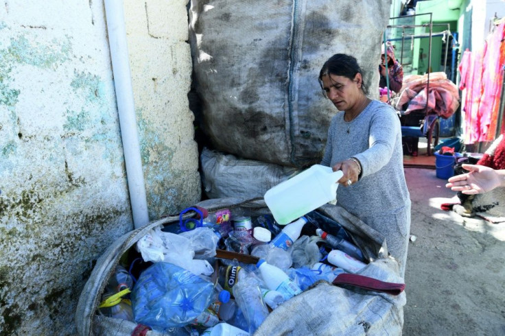 Some Roma still collect bottles and cans in hopes that business will soon resume, even though they fear contamination from rummaging through other people's wasteÂ 