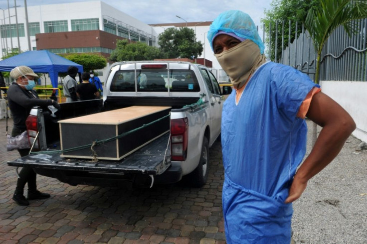 A man wearing a protective suit to identify a relative outside the morgue of the Hospital General Guasmo Sur in Guayaquil, Ecuador