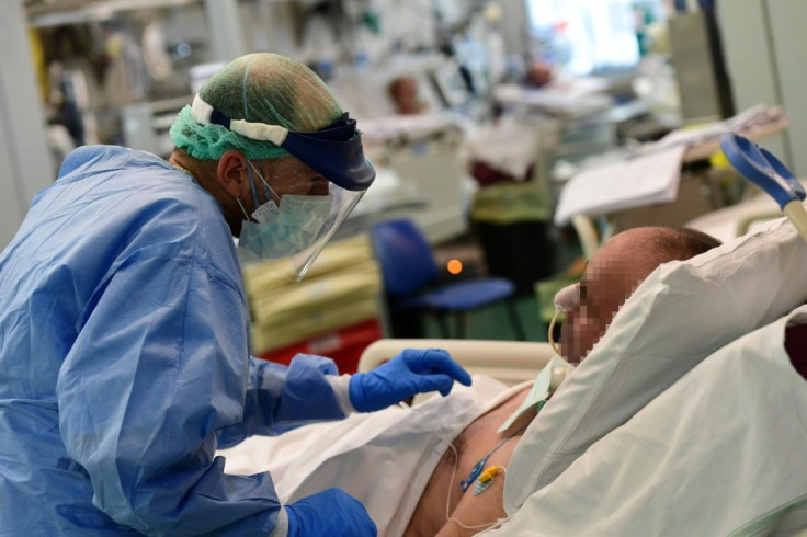 A member of the medical staff speaks with a patient in the COVID-19 unit of the Policlinico Sant'Orsola-Malpighi hospital in Bologna, Italy