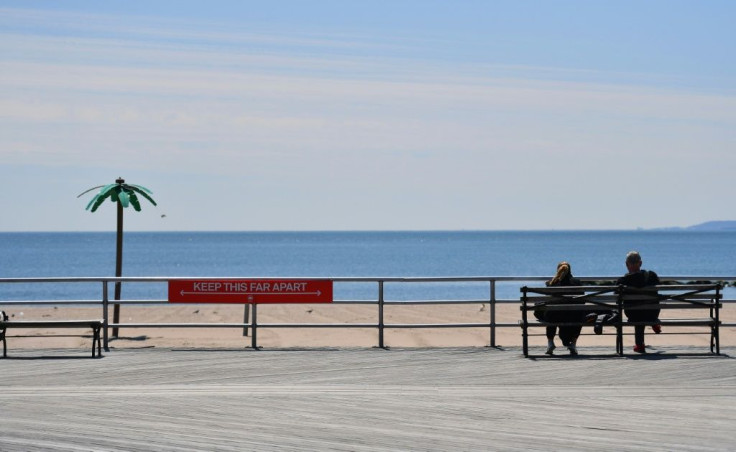 A sign reading 'Keep This Far Apart', remind speople of social distancing, is seen on the Coney Island boardwalk  in New York City