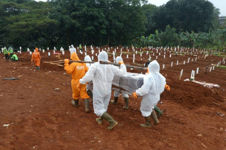 Workers carry a coffin of a coronavirus victim for burial at a cemetery in Jakarta. City officials have noted a huge increase in the number of burials, a rise not reflected by government virus death tolls