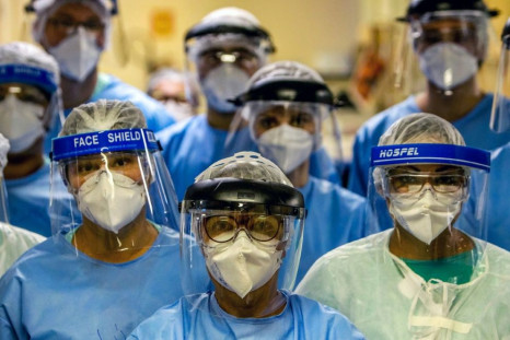 A group of doctors working with patients infected with the novel coronavirus COVID-19 wear face shields at the Intensive Care Unit of the Hospital de Clinicas in Porto Alegre, Brazil