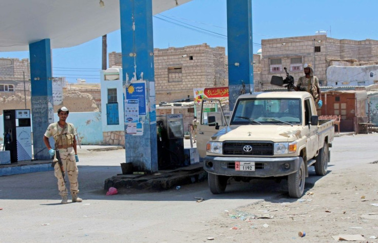 Yemeni pro-government fighters gather at a petrol station on April 10 in the coastal town of Shihr, in the southern Hadramawt province where the country's first case of coronavirus was reported