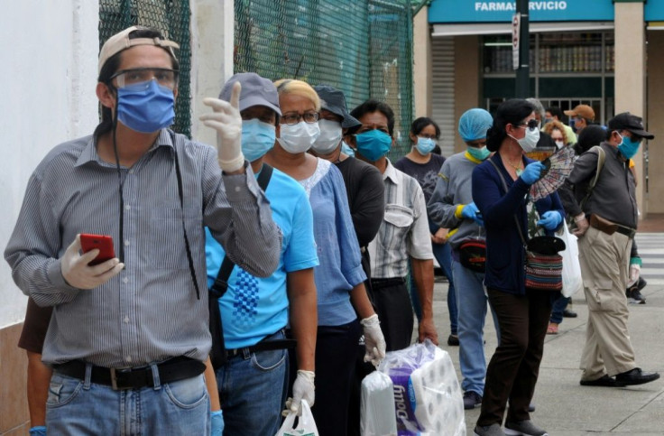 People queue outside a pharmacy in downtown Guayaquil, Ecuador, on April 15