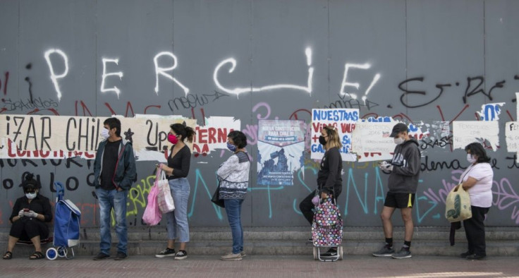 People queue at a supermarket in the Del Bosque commune in Santiago, on April 15