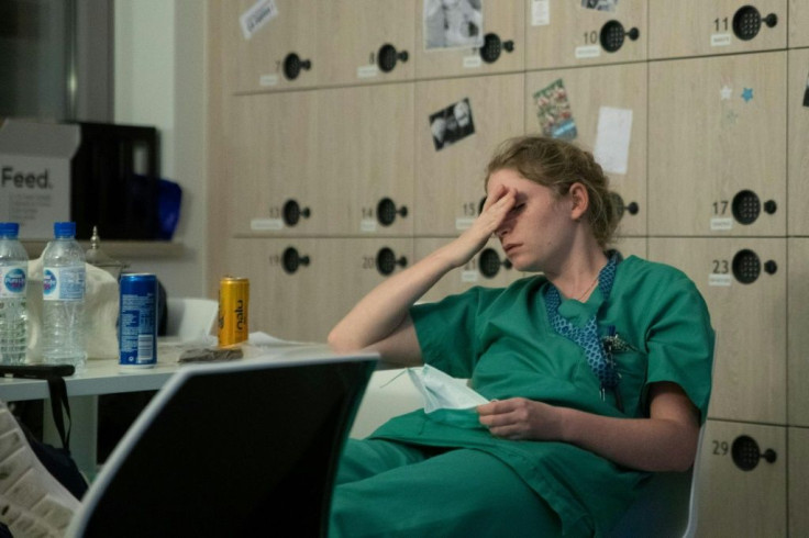 Mathilde Dumont, a 27-year-old nurse, rests during her night shift in the intensive care unit exclusively for COVID-19 patients at the Ixelles Hospital in Brussels
