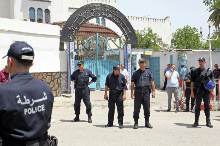 Algerian policemen stand outside the El Harrach prison in a suburb of the capital Algiers
