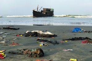 Belongings of Rohingya refugees rest on the shore as their boat remains anchored off Teknaf in Bangladesh on Thursday