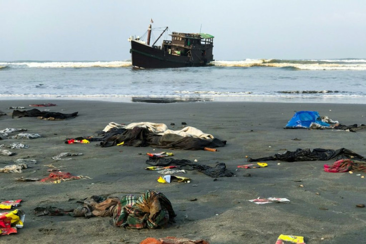 Belongings of Rohingya refugees rest on the shore as their boat remains anchored off Teknaf in Bangladesh on Thursday