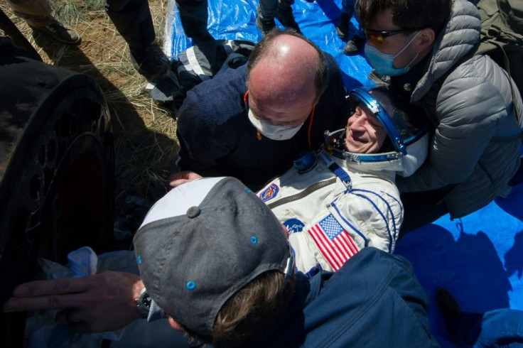 NASA astronaut Andrew Morgan is helped out of the Soyuz MS-15 capsule