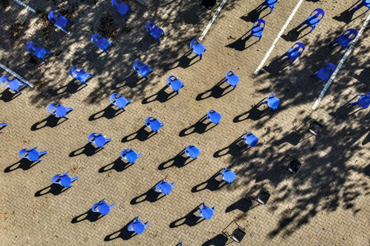 Aerial view of chairs arranged in order to maintain social distancing at a parking lot in Soweto for food distribution