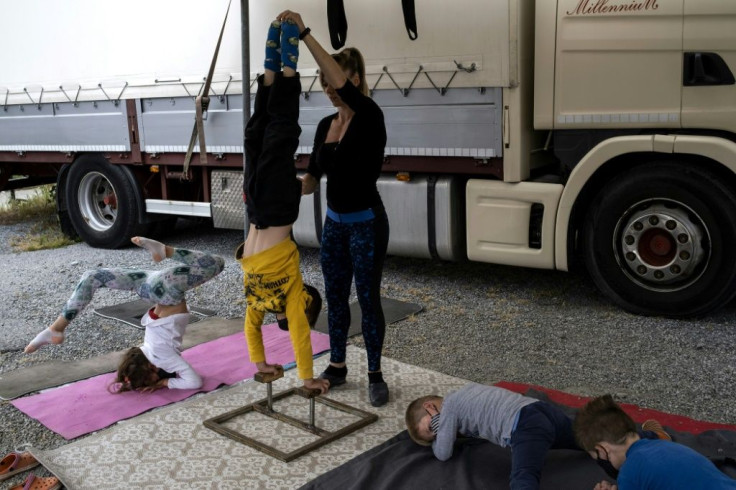 Children and a performer of the "Circo Millennium" train in Savona, northwestern Italy, during a strict lockdown. The show cannot be performed and the animals depend on donated food.