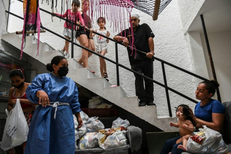Activist Maria Isabel Diaz gives out groceries to tenants in the low-cost hotel she manages, where sex workers live and work in Medellin, Colombia
