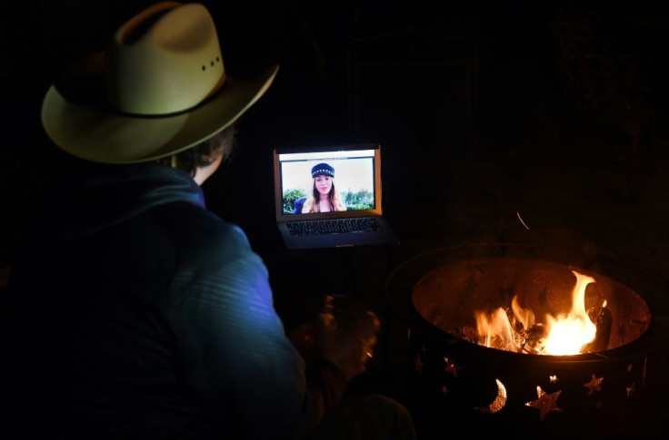 Neighbors in Virginia gather around a fire pit to watch Beyonce speak during the "One World: Together at Home" concert  that also featured performances from The Rolling Stones and Taylor Swift