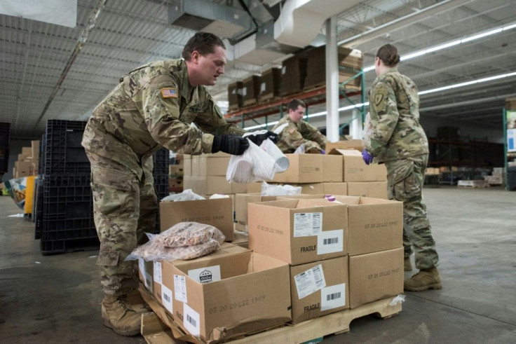 National Guard soldiers prepare packages of food in Indiana