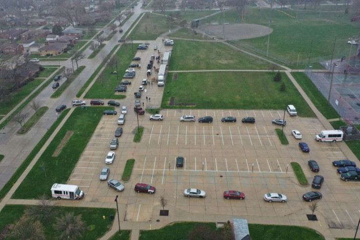 Cars line up at a food bank in Oak Park, Michigan