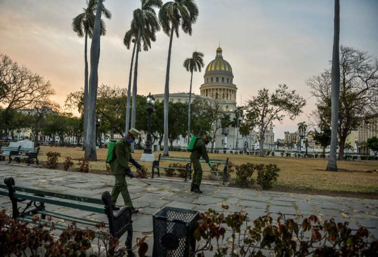 Cuban soldiers disinfect a square in Havana that has been left virtually deserted due to the coronavirus outbreak