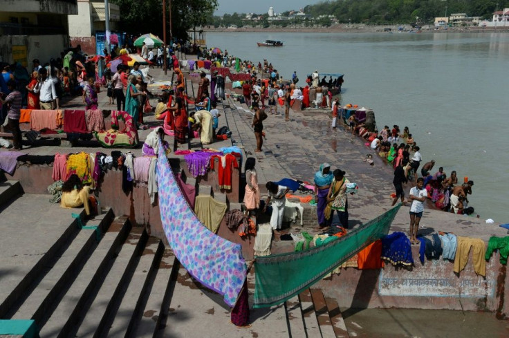 Indians dry their clothes after taking a holy dip in the River Ganges at Rishikesh, where about 700 foreign tourists remain as India's virus lockdown continues