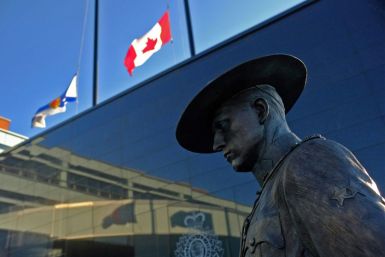 Flags of Nova Scotia and Canada fly at half-staff outside the Nova Scotia Royal Canadian Mounted Police (RCMP) headquarters in Dartmouth, Nova Scotia, after at least 10 people including an RCMP officer were killed in a shooting rampage