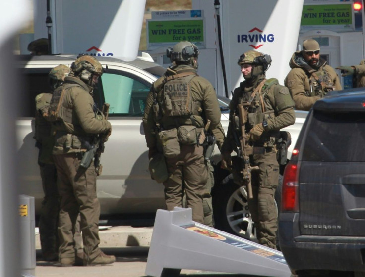 Members of a Royal Canadian Mounted Police tactical unit confer after a suspect in a deadly shooting rampage was neutralized at the Big Stop near Elmsdale, Nova Scotia