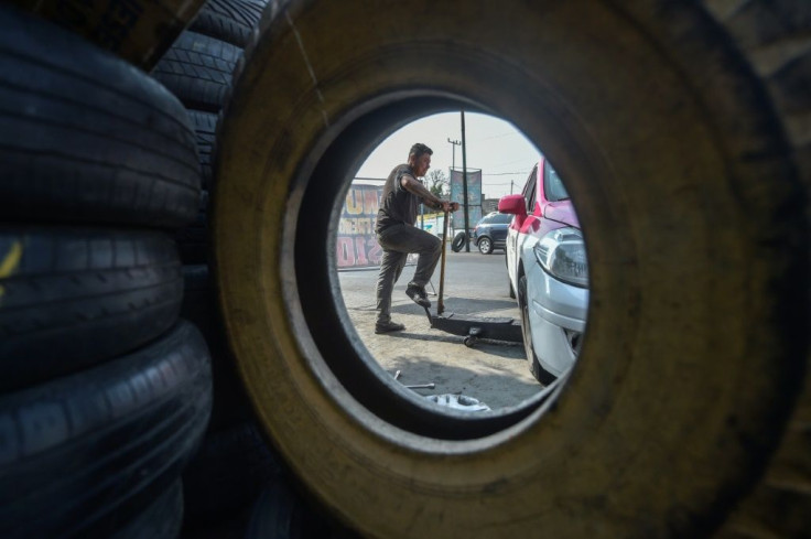 A man works at a tyre repair shop in Mexico City, on April 15, 2020 during the novel coronavirus COVID-19 pandemic