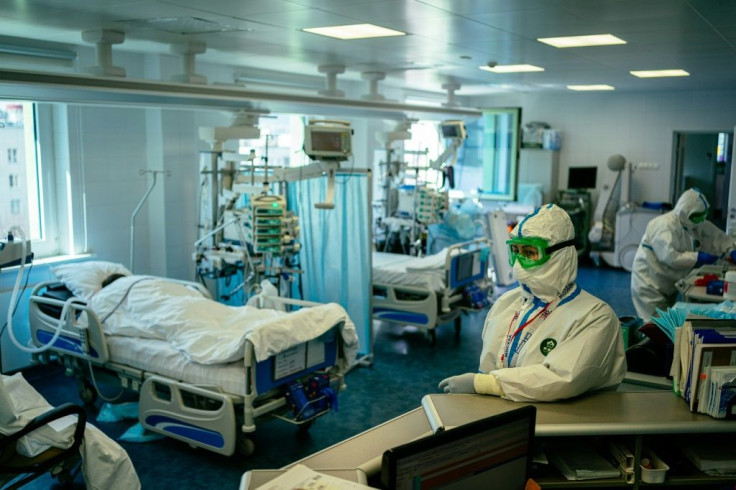 Medical workers wearing protective equipment treat patients infected with COVID-19 in Moscow's K+31 private hospital
