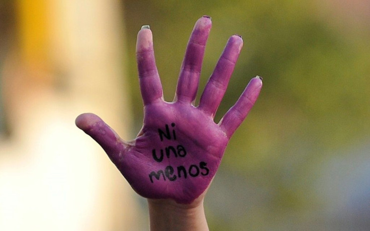 An activist displays her hand reading "Not One Less" during a march to mark the International Day for the Elimination of Violence Against Women in Naucalpan, Mexico