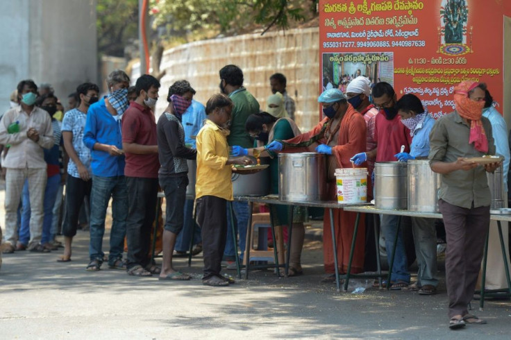 People line up in the Indian city of Hyderabad to receive free food distributed by a Hindu group during a government-imposed nationwide lockdown