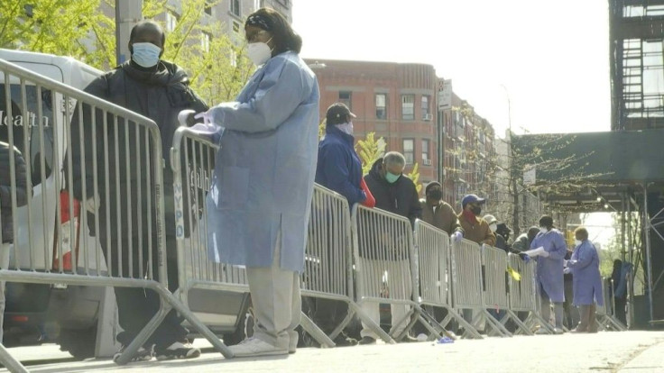 New Yorkers wait in line at a coronavirus testing site in Harlem