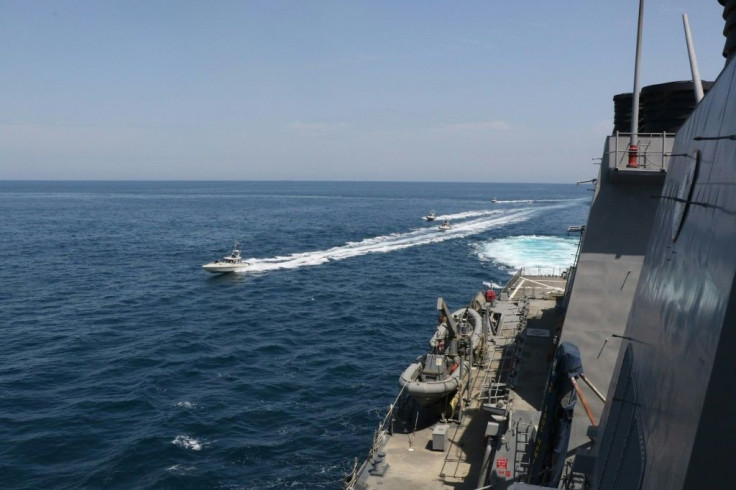 A photo released by the US Navy shows Iranian Islamic Revolutionary Guard Corps Navy vessels in the Gulf near the guided-missile destroyer USS Paul Hamilton and other US military ships