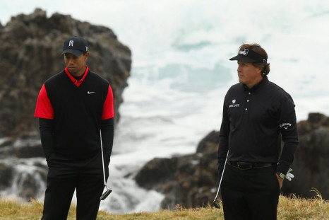 Tiger Woods, left, and Phil Mickelson are reported to be ready to tee it up for charity by holding a golf match that would also include Tom Brady and Peyton Manning