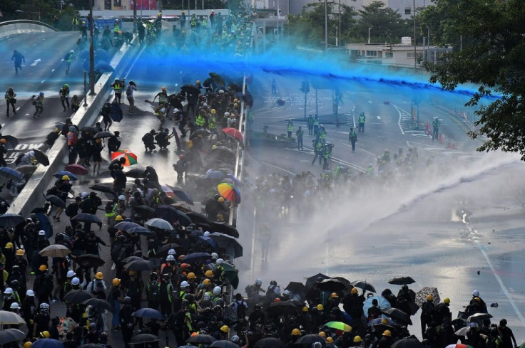 Police fire water cannon outside government headquarters in Hong Kong in September 2019
