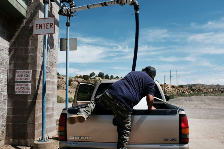 A man from the Navajo Nation collects water from a public water pump on June 7, 2019 in the town of Gallup, New Mexico; up to 30 percent of Navajo Nation households dont have clean running water