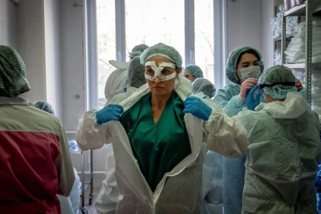 Medical workers get ready for a shift treating coronavirus patients at the Spasokukotsky clinical hospital in Moscow