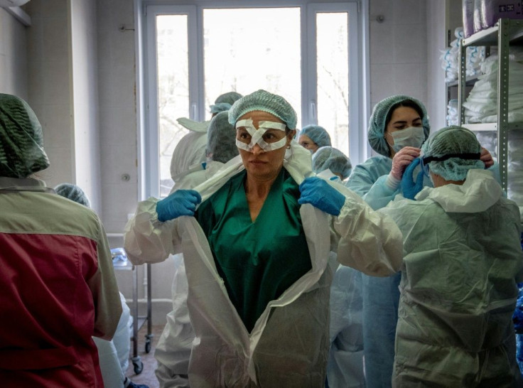 Medical workers get ready for a shift treating coronavirus patients at the Spasokukotsky clinical hospital in Moscow