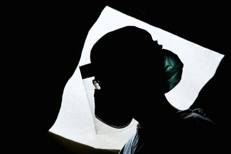 A nurse conducts tests for the new coronavirus in a tent in the grounds of a private hospital in Stockholm