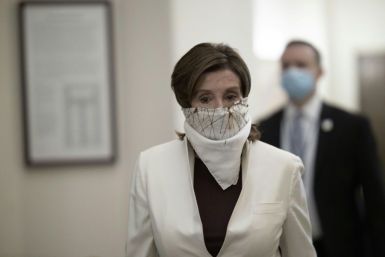 Democratic Speaker of the House Nancy Pelosi wore a face covering as she arrived on Capitol Hill to vote on the latest US stimulus bill