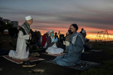 A small group of Muslim clerics gather for prayer before looking for the crescent moon which will signal the start of the month of Ramadan in Seapoint on April 23, 2020, in Cape Town; Muslims around the world are preparing to celebrate the start of the fa