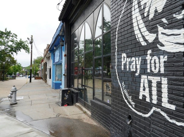 A sign stating Pray For Atlanta is seen on the side of a restaurant in the Georgia capital as it prepares to ease a coronavirus shutdown