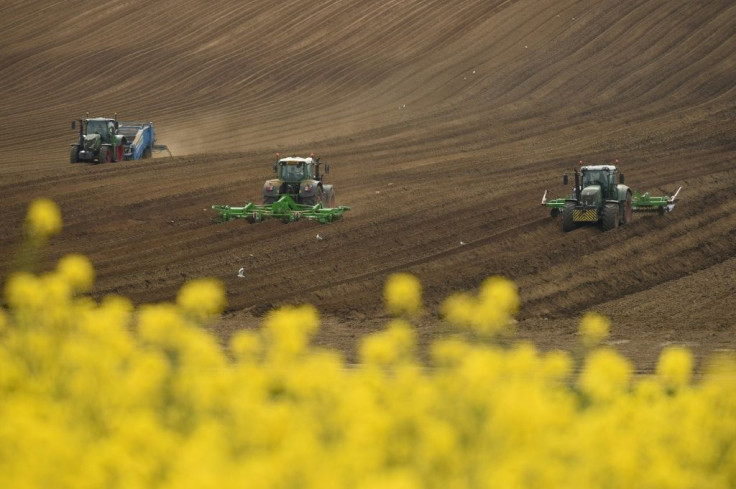 Farmers prepare a field for planting near Pontefract, as the Bank of England warns of Britain's worst recession in centuries