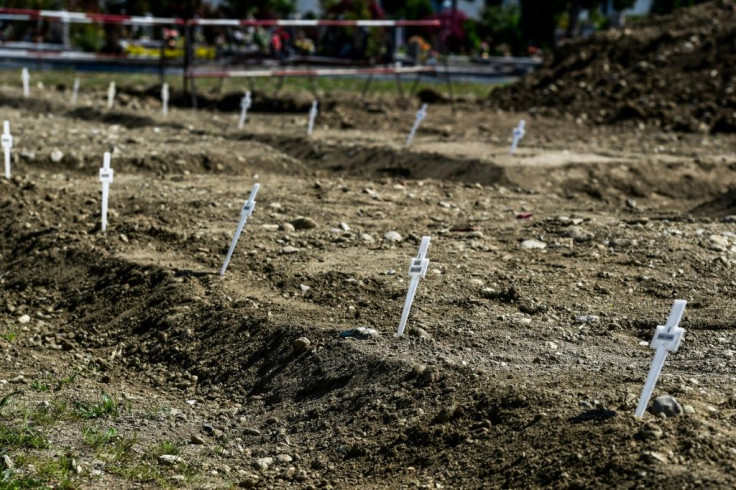 Crosses mark the graves of some 60 unclaimed victims of coronavirus in a cemetery near Milan
